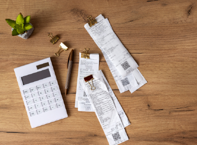 inflation blog tile image with receipts and calculator on table